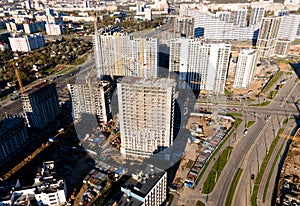 Tower cranes in action at construction site. Crane during formworks. Ð¡onstruction site with foundation pit for monolithic. First