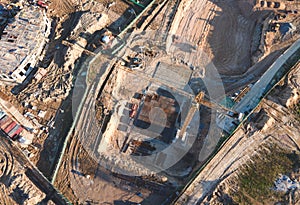 Tower cranes in action at construction site. Crane during formworks. Soil Compactor leveling ground for construct of foundation