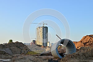 Tower cranes constructing a new building at a construction site. Renovation program, concept of the building industry.