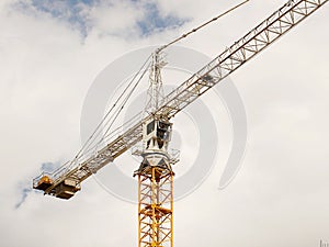 Tower cranes work during the construction of a multi-story building. New apartments for residents and premises for offices. Risky