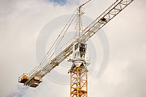 Tower cranes work during the construction of a multi-story building. New apartments for residents and premises for offices. Risky