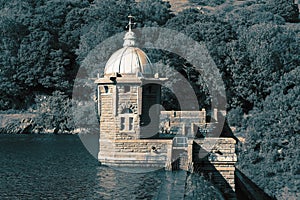 Tower at the Elan Valley Dam, in Wales, reflected in the reservoir.