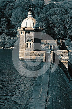 Tower at the Elan Valley Dam, in Wales, reflected in the reservoir.