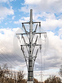 The tower of a high-voltage electricity line against a cloudy sky