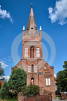 The tower of the historic, Gothic red brick church in the city of Skwierzyna