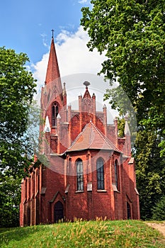 The tower of the historic, neo-Gothic red brick church in the village of Chycina
