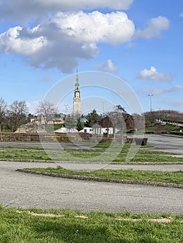 The tower of the Jasna Gora Monastery in Czestochowa, Poland, seen from a distance, from the west with clouds in the sky