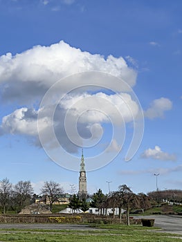 The tower of the Jasna Gora Monastery in Czestochowa, Poland, seen from a distance, from the west with clouds in the sky