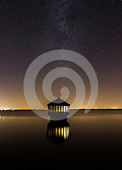 Tower in lake under the stars