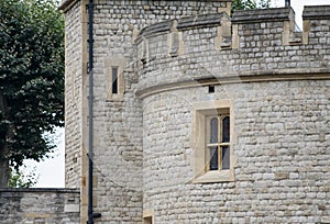 Tower of London in London, England - detail of exterior wall and tower with ramparts.