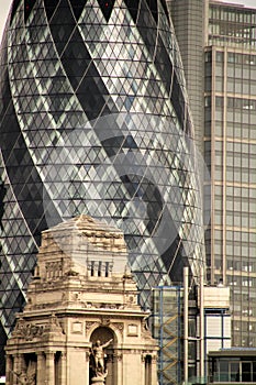 Tower in London, UK, surrounded by modern skyscrapers