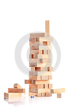 tower made of wooden blocks falling on white background