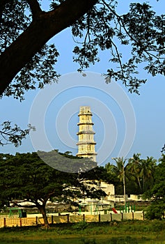 The tower of Manora fort with tree branches.