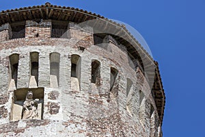 Tower of medieval italian castle on blue sky