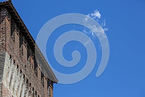 Tower of medieval italian castle on blue sky