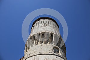 Tower of medieval italian castle on blue sky