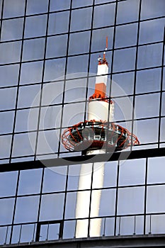 Tower mirrored in glass steel building