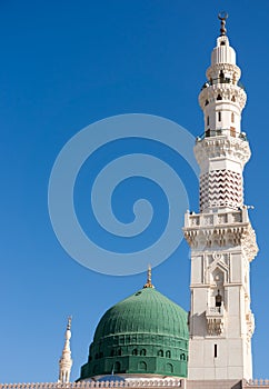 Tower of the Nabawi mosque againts blue sky photo