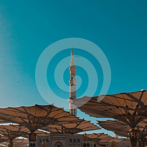 A tower of nabawi mosque with the umbrella open