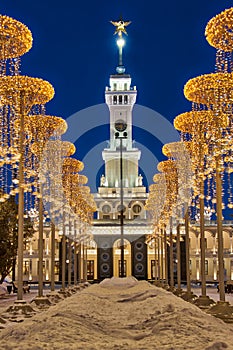 Tower of Northern River Station Framed by Christmas Lights in Twilight