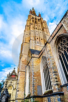 The tower of Onze Lieve Vrouwekerk Church of Our Lady in the medieval city of Bruges, Belgium