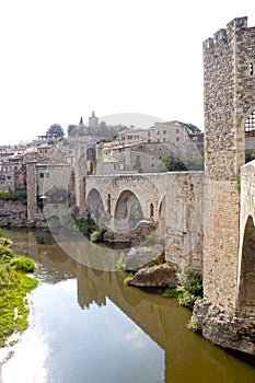 Tower over a river and its reflection