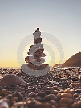 Tower of pebble in the Kabak Valley beach and sunset