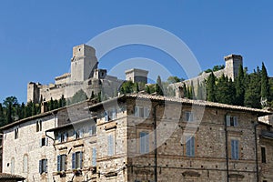 Tower and rampart of the Rocca Maggiore fortress dominating the city of Assisi in Italy