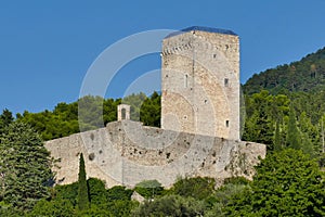 Tower and rampart of the Rocca Maggiore fortress dominating the city of Assisi in Italy