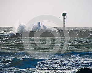 Metal Tower Rock Jetty Crashing Wave