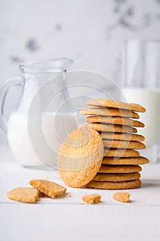Tower from shortbread kamut cookies with glass and jug of milk
