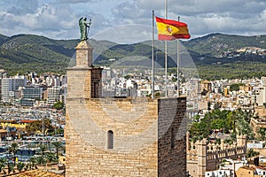 The tower and the Spanish flag on the Royal Palace of La Almudaina, Palma de Mallorca, Spain