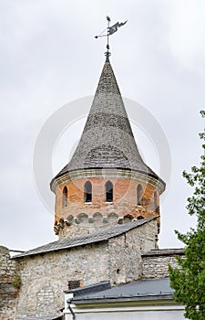 Tower with spire roof and weather vane of ancient castle