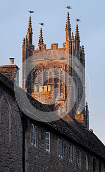 Tower of St Andrew`s Church rises above local houses in the historic village of Mells in rural Somerset, UK