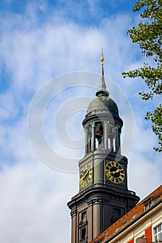 The tower of St Michaels church Hauptkirche Sankt Michaelis with people on the viewing platform on a bright summer day with blue