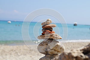 Tower of stones on the beach at the seaside in the summer