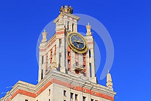 Tower with thermometer of Lomonosov Moscow State University MSU against blue sky in sunny summer evening