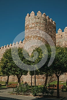 Tower on wall next to wooden garden at Avila