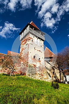 Tower and walls of fortified church Alma Vii, Transylvania. Romania