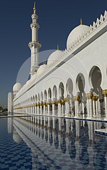 Tower, water pool and arches at the stunning Sheikh Zayed Grand Mosque in Abu Dhabi UAE