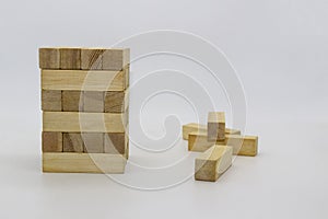 Tower wooden block, builds tower from wooden blocks against white background. The wooden bricks lying around randomly