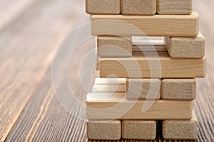 The tower of wooden blocks placed on a table.