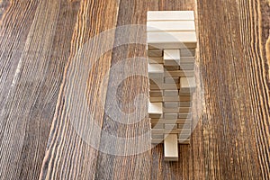 The tower of wooden blocks placed on a table.