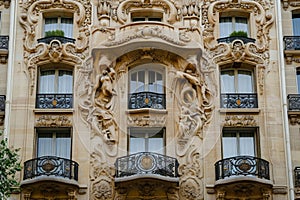 A towering building with numerous windows and balconies providing an architectural view of urban development, Art Nouveau hotel