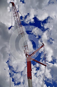 a towering crane machine against a blue sky background