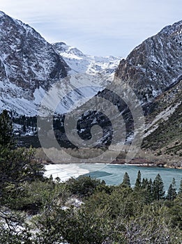 The towering Easter Sierra rises behind the freezing Parker Lake