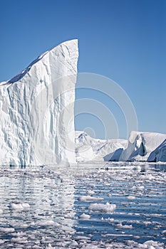 Towering great icebergs in the Ilulissat Icefjord in Greenland