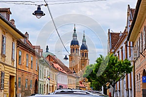 Towers of Byzantine style basilica Holy Trinity Cathedral Catedrala Sfanta Treime din Sibiu as seen from the city streets.