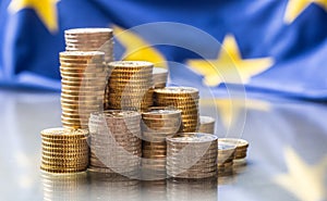 Towers with euro coins and flag of European Union in the background photo