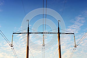 towers and high-voltage wires against the blue sky. Electric net